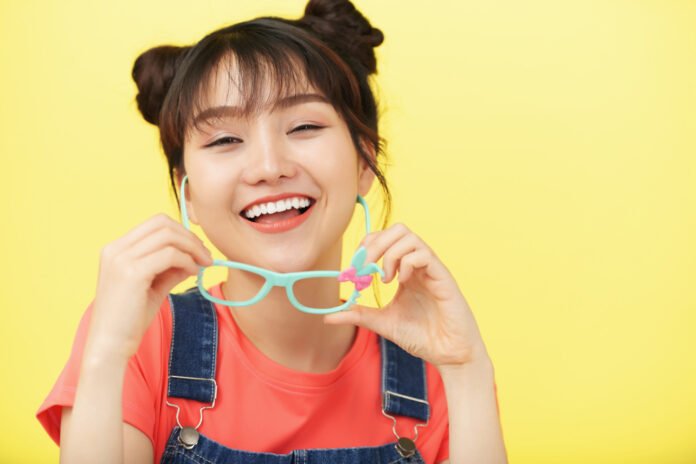 jovem asiatica sorridente com seus oculos.