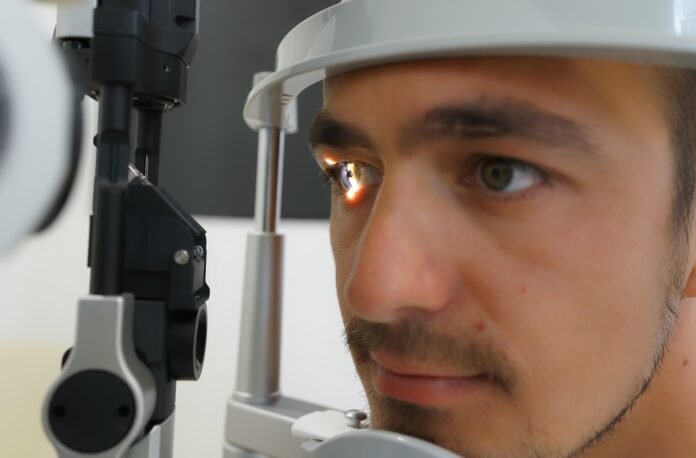 um jovem tendo seus olhos analisados em um auto refrator.